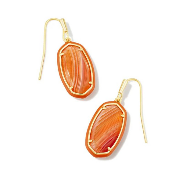 Orange framed, oval shaped drop earrings with a center orange stone and a gold fish hook earring. These earrings are pictured on a white background. 