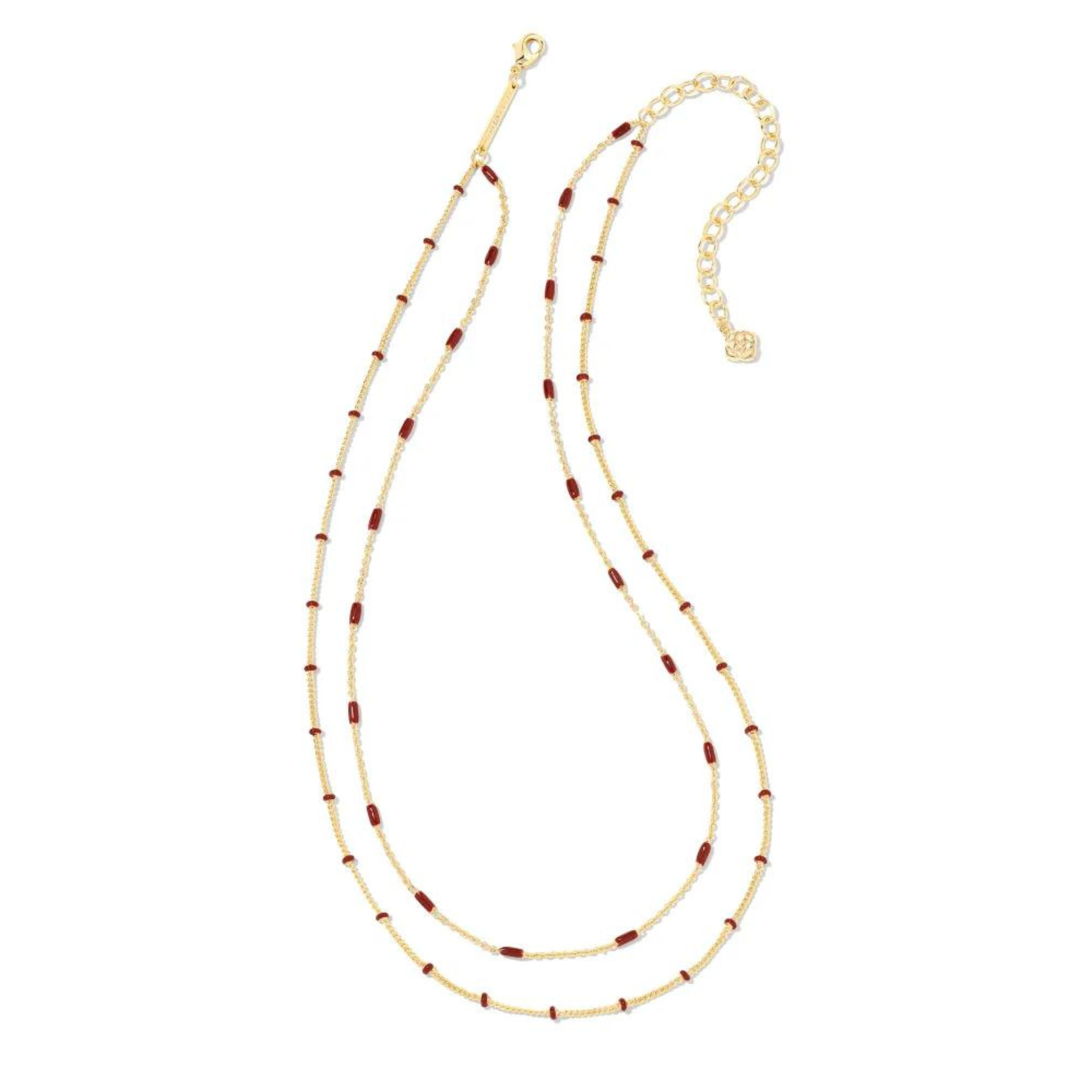 Two strand, adjustable chain necklace with burgundy enamel spacers. This necklace is pictured on a white background. 
