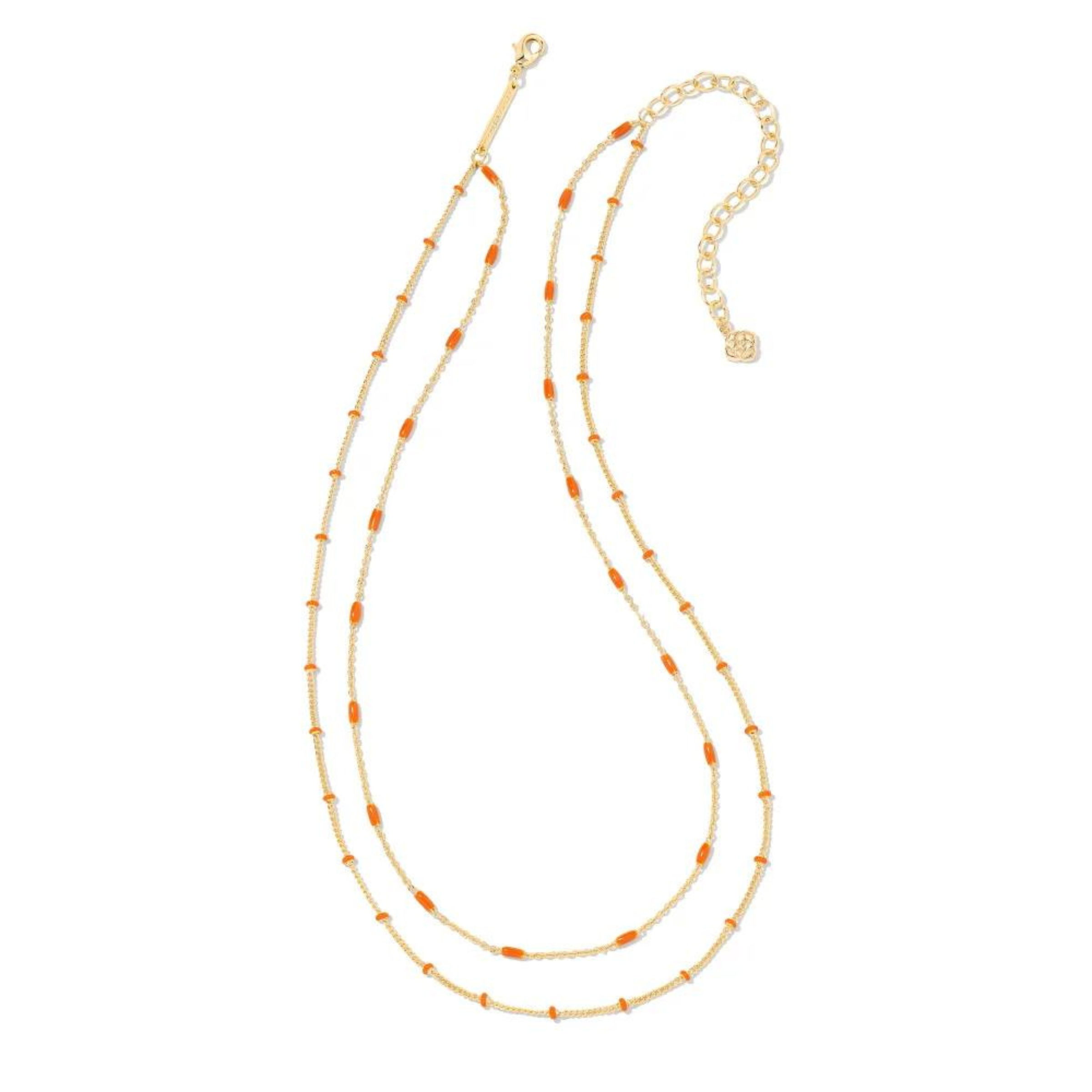Two strand, adjustable chain necklace with orange enamel spacers. This necklace is pictured on a white background. 