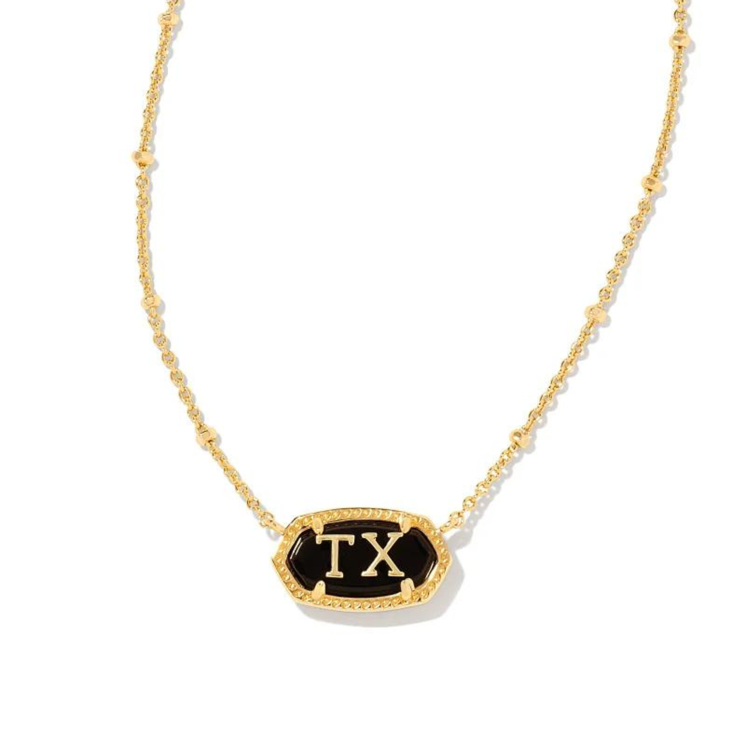 Pictured on a white background is a gold chain necklace with a black stone, oval pendant. This pendant has a gold outline and gold "TX" in the center.  
