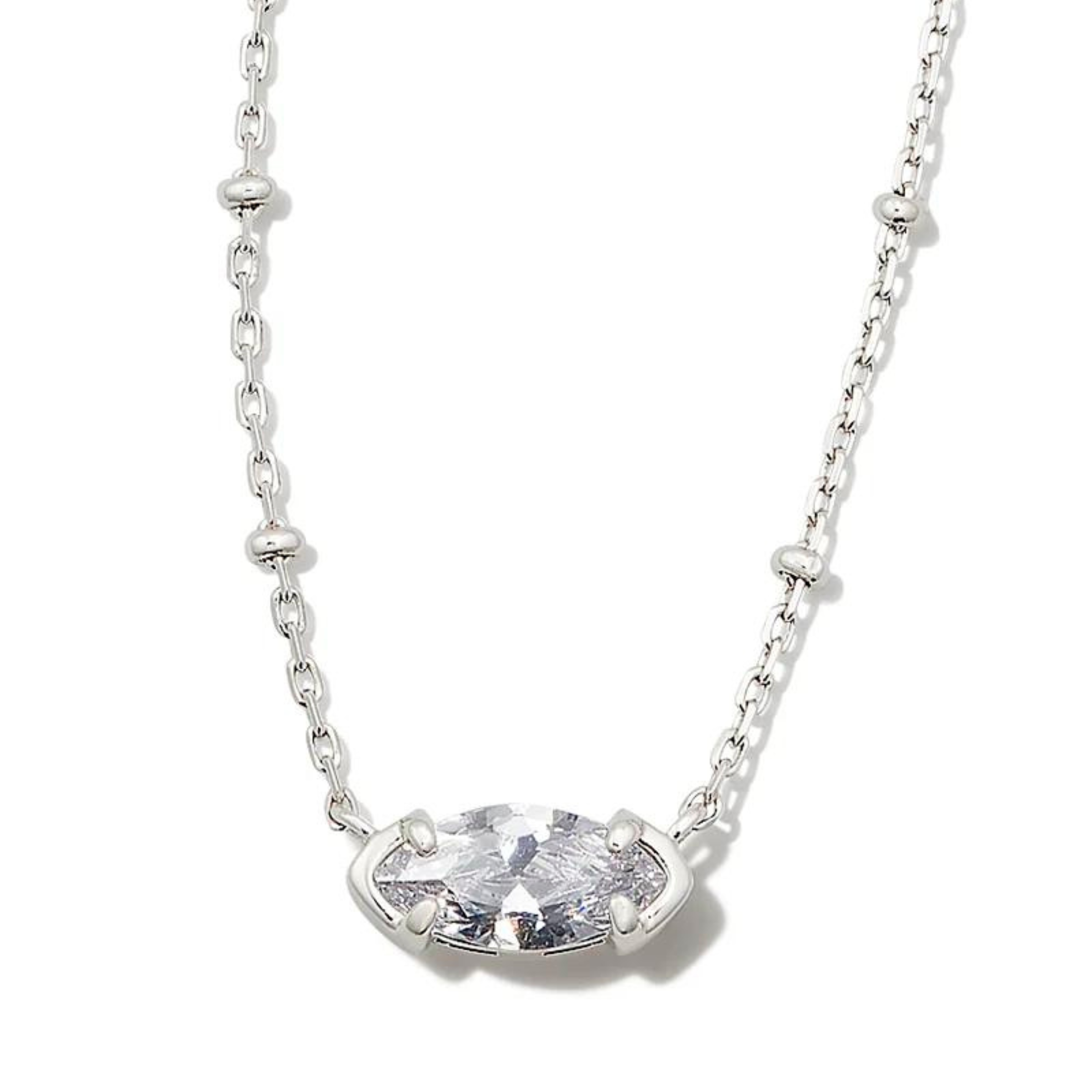 Silver chain necklace with a clear crystal oval pendant. This necklace is pictured on a white background. 