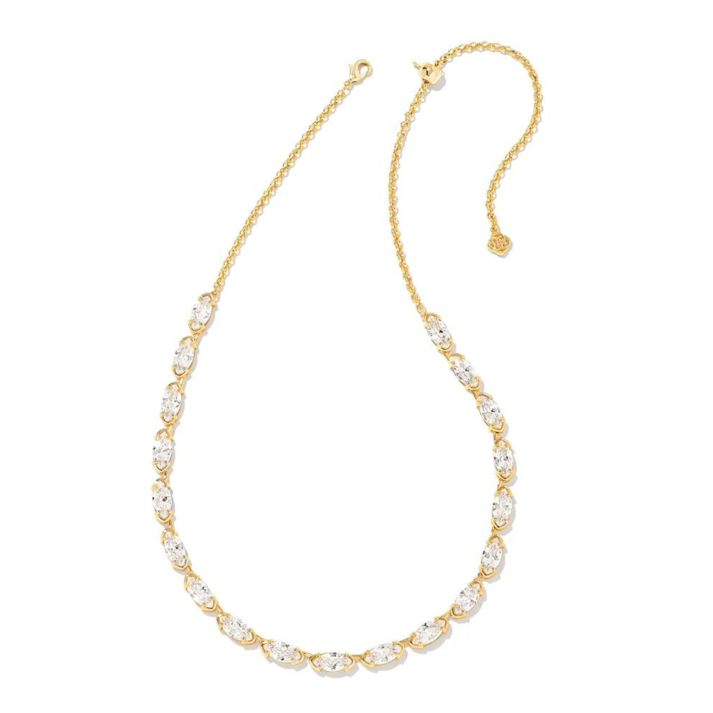Gold tennis necklace with clear crystals. This necklace is pictured on a white background. 