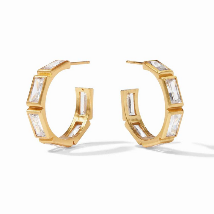 Gold hoop earrings with clear, rectangle crystals pictured on a white background. 