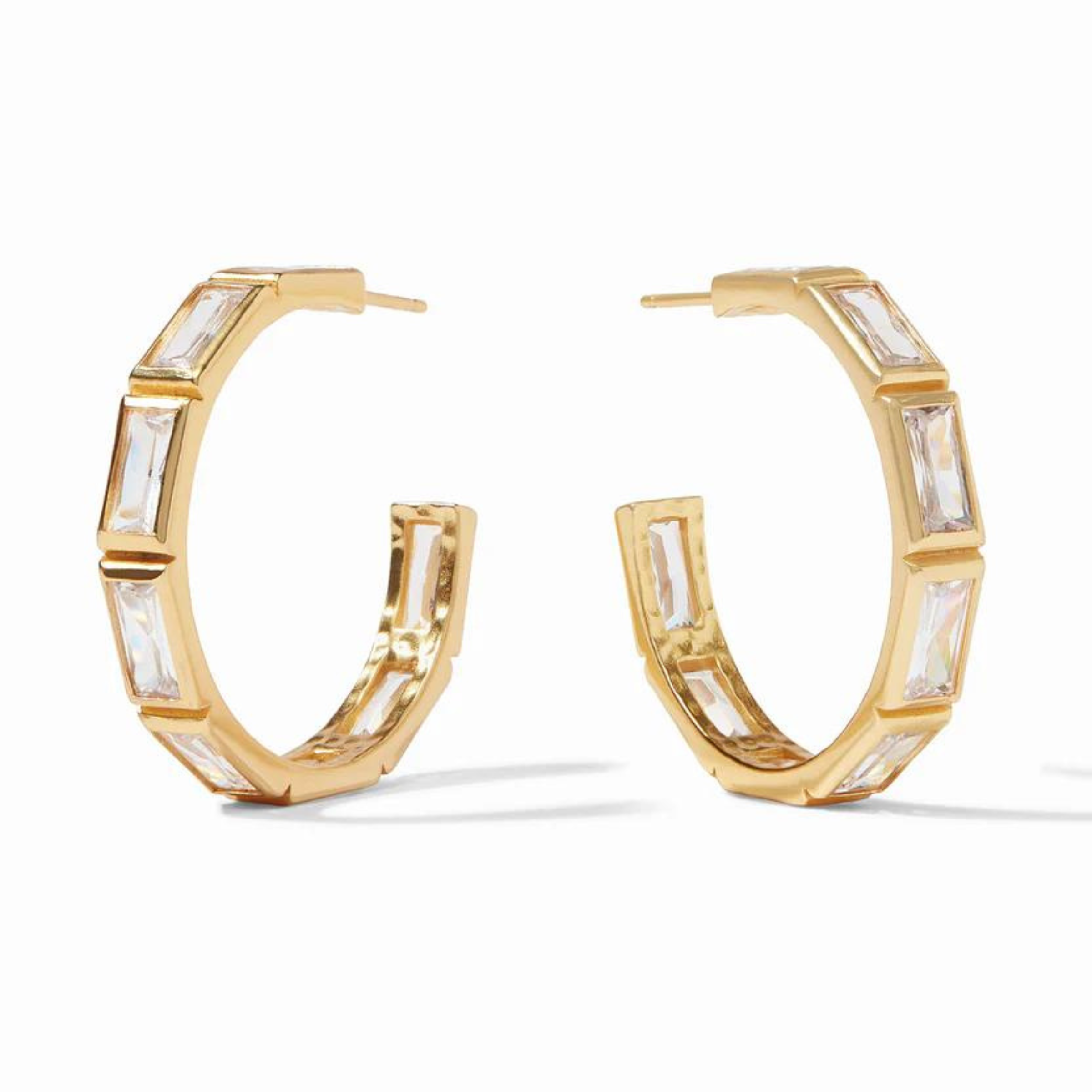 Gold hoop earrings with clear, rectangle crystals pictured on a white background. 