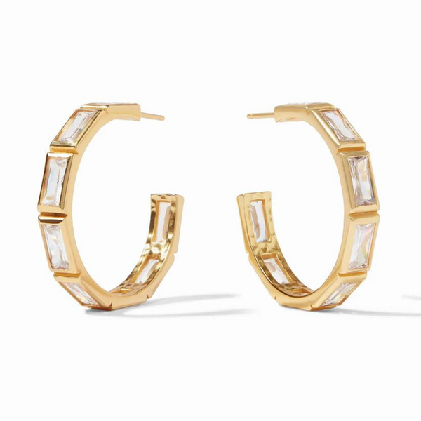 Gold hoop earrings with clear, rectangle crystals pictured on a white background. 