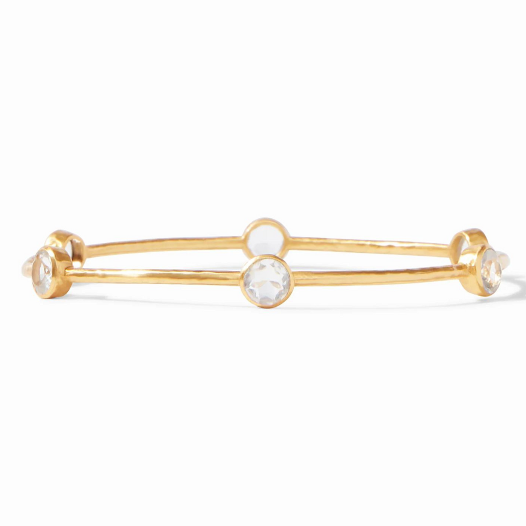 Gold, hammered bangle with clear crystals. This bracelet is pictured on a white background. 