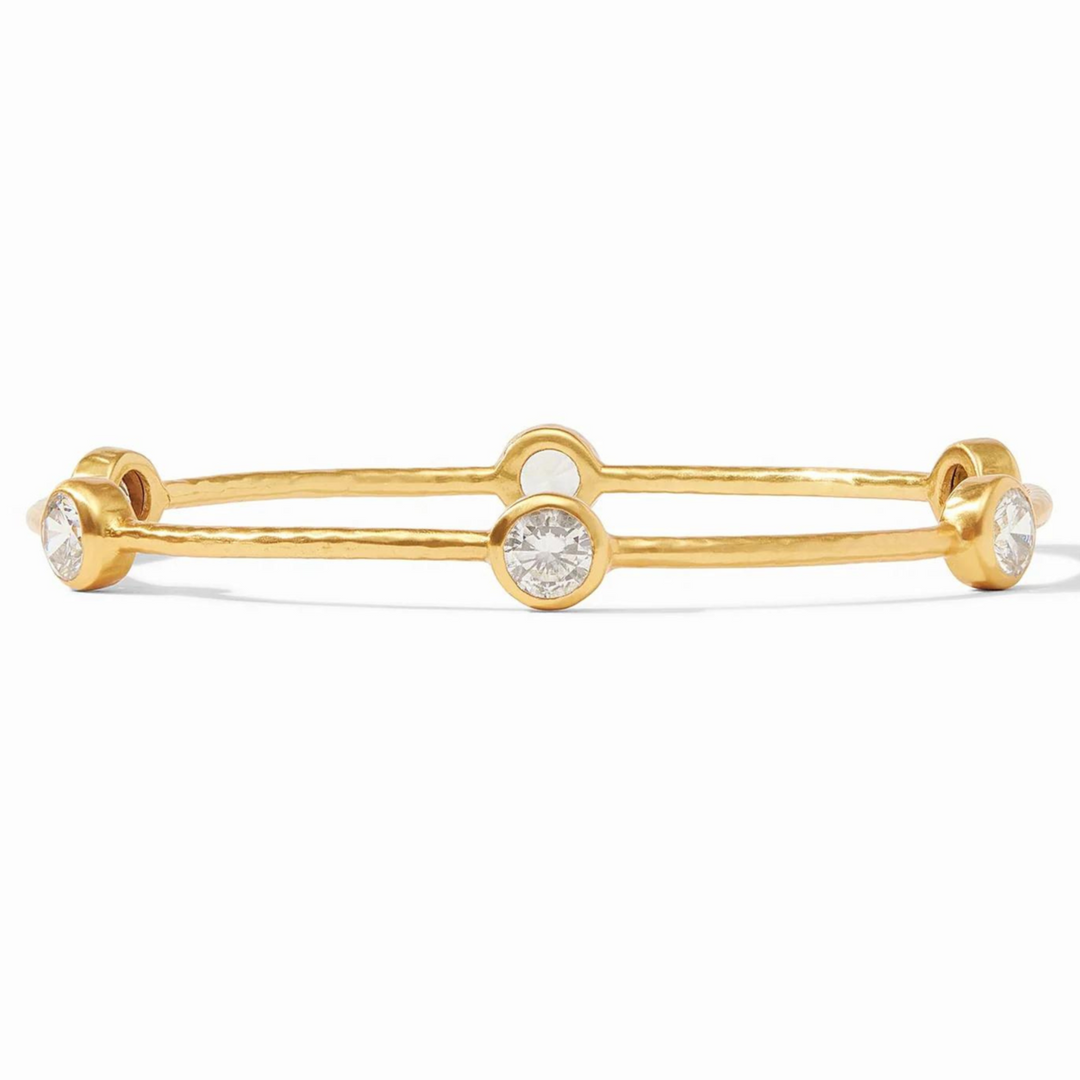 Gold, hammered bangle with cz crystals. This bracelet is pictured on a white background. 