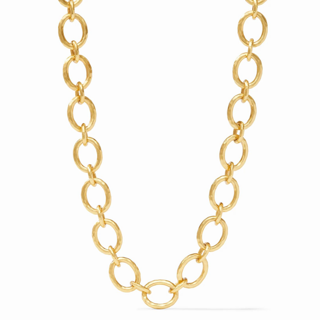 Gold, hammered chain link necklace pictured on a white background. 