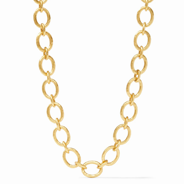 Gold, hammered chain link necklace pictured on a white background. 