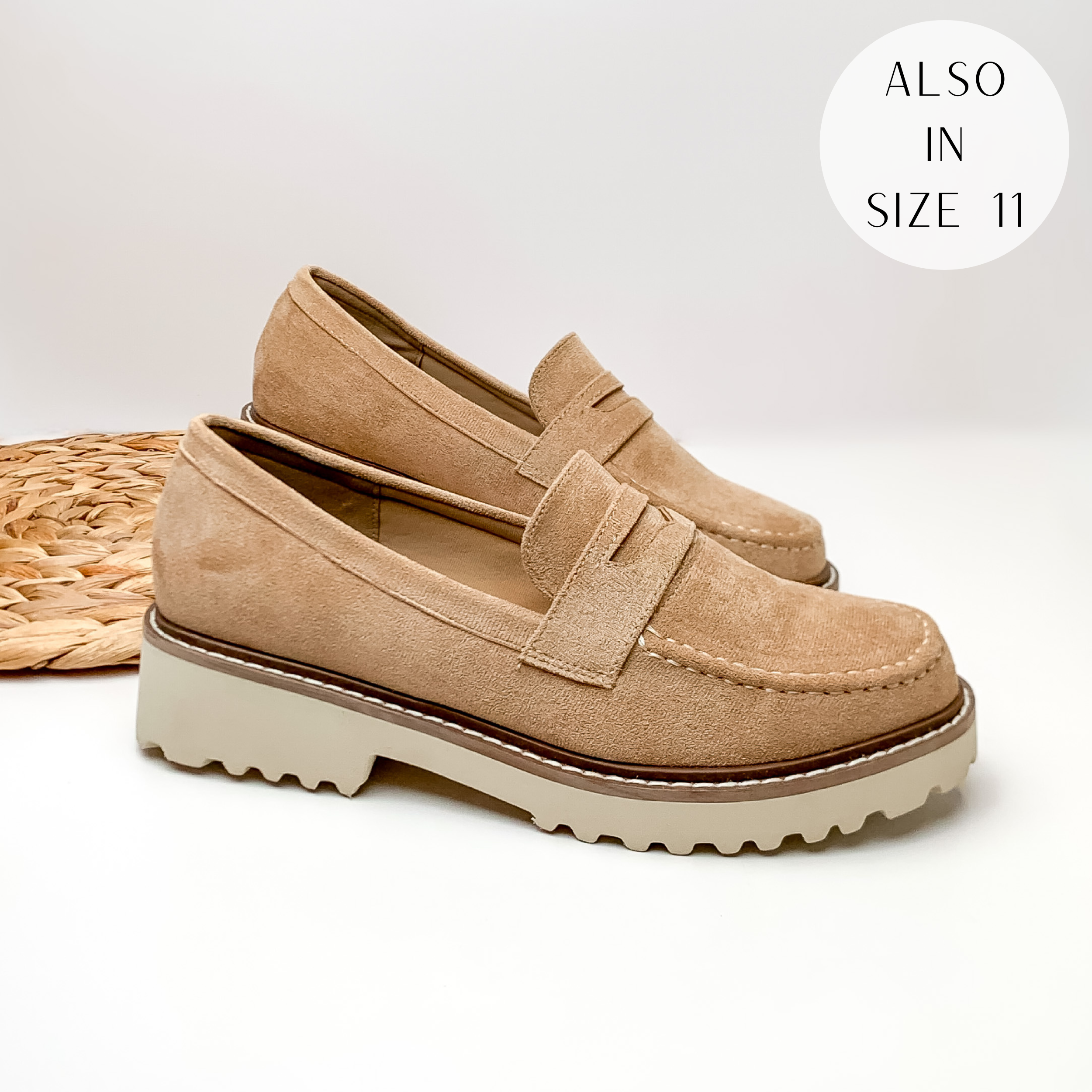 Tan suede slip on loafers with a white rubber sole. These loafers are pictured laying on a white background.