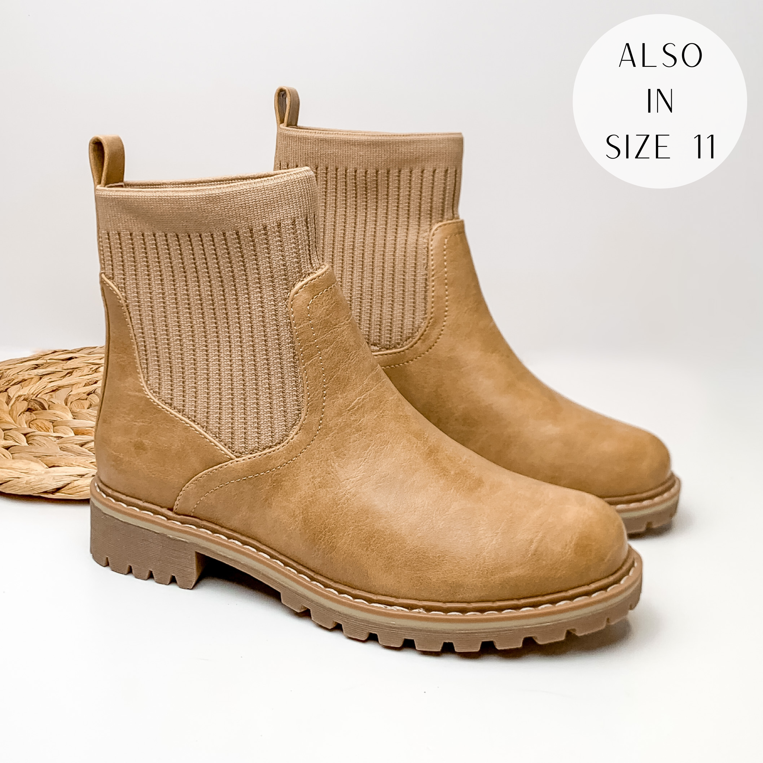 Slip on booties in tan with a tan, rubber sole. These boots are pictured on a white background.