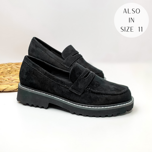 Black suede slip on loafers with a black rubber sole. These loafers are pictured laying on a white background.