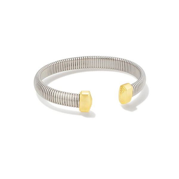 Pictured is a silver cuff bracelet with gold ends on a white background. 