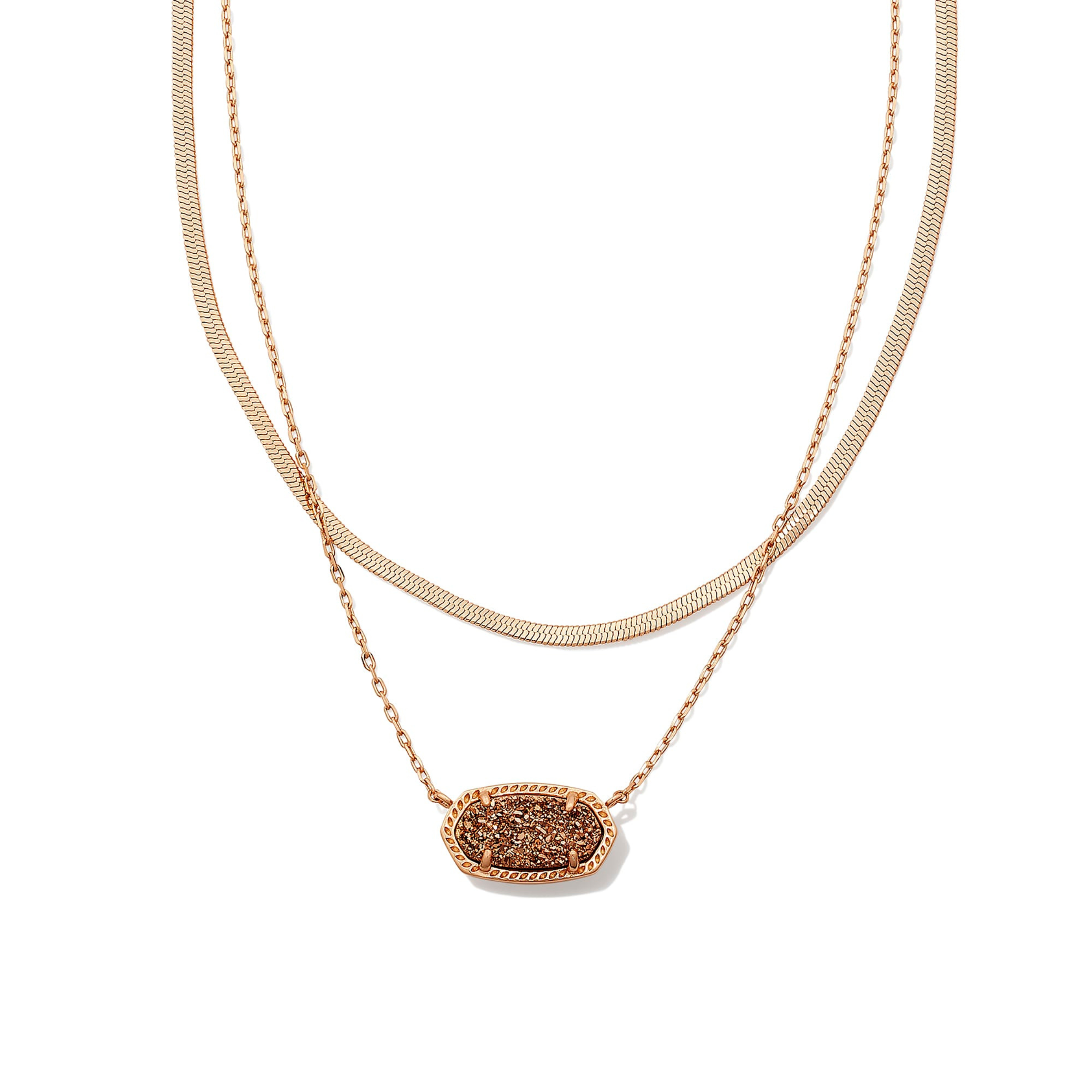 Pictured is a two strand, rose gold chain necklace with an oval rose gold drusy pendant. This necklace is pictured on a white background.    