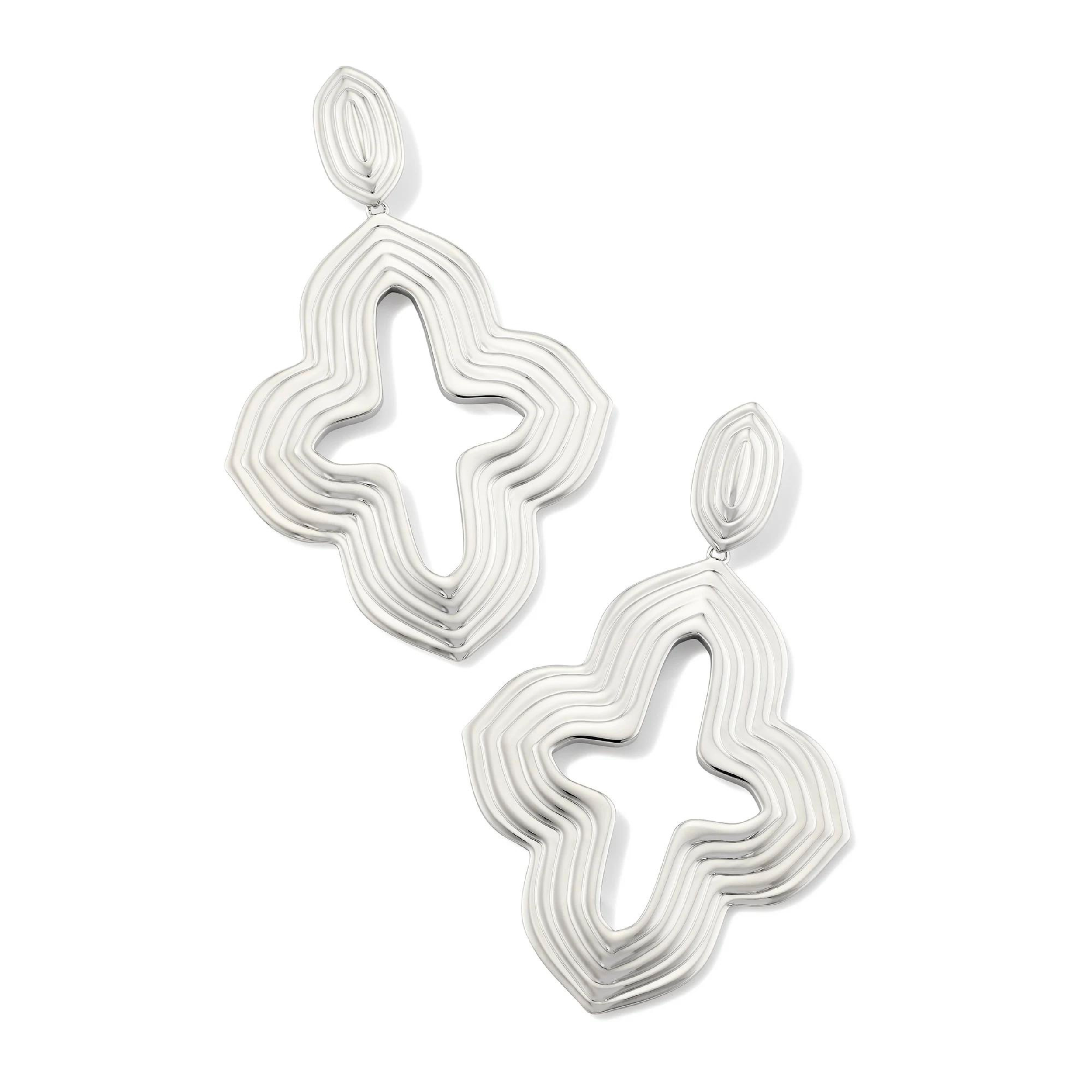 Pictured is a silver, statement drop earrings on a white background.    