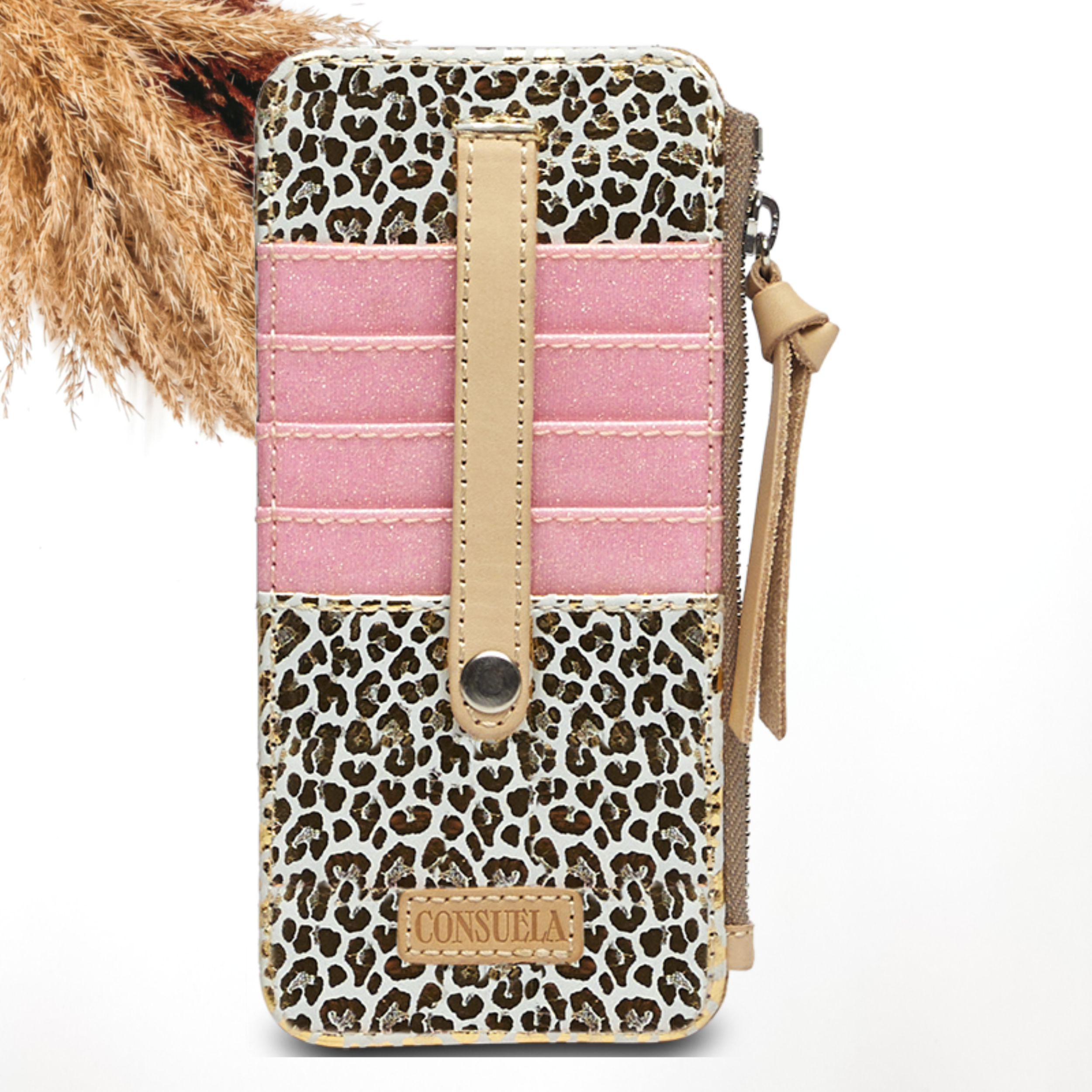 Pictured on a white background is a card organizer with a light tan leather zipper pull on the side and a button closure over the pockets. This card organizer is white with a metallic gold leopard print design with the pockets in a pink glitter design. 