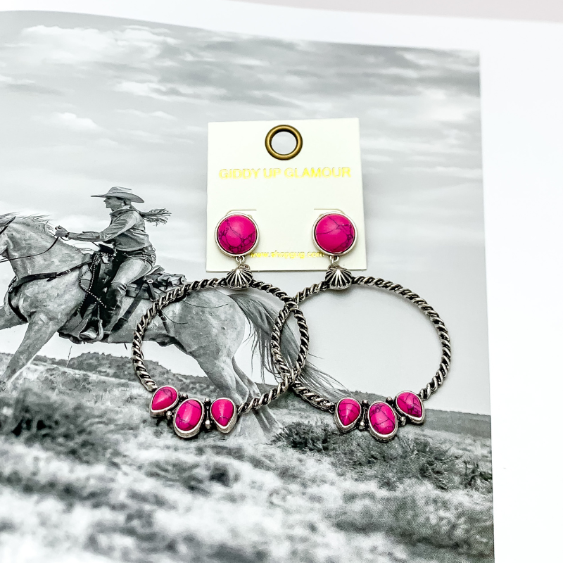 Western Moment Silver Tone Hoop Earrings With Stones in Hot Pink. Pictured with a western scene in the back.