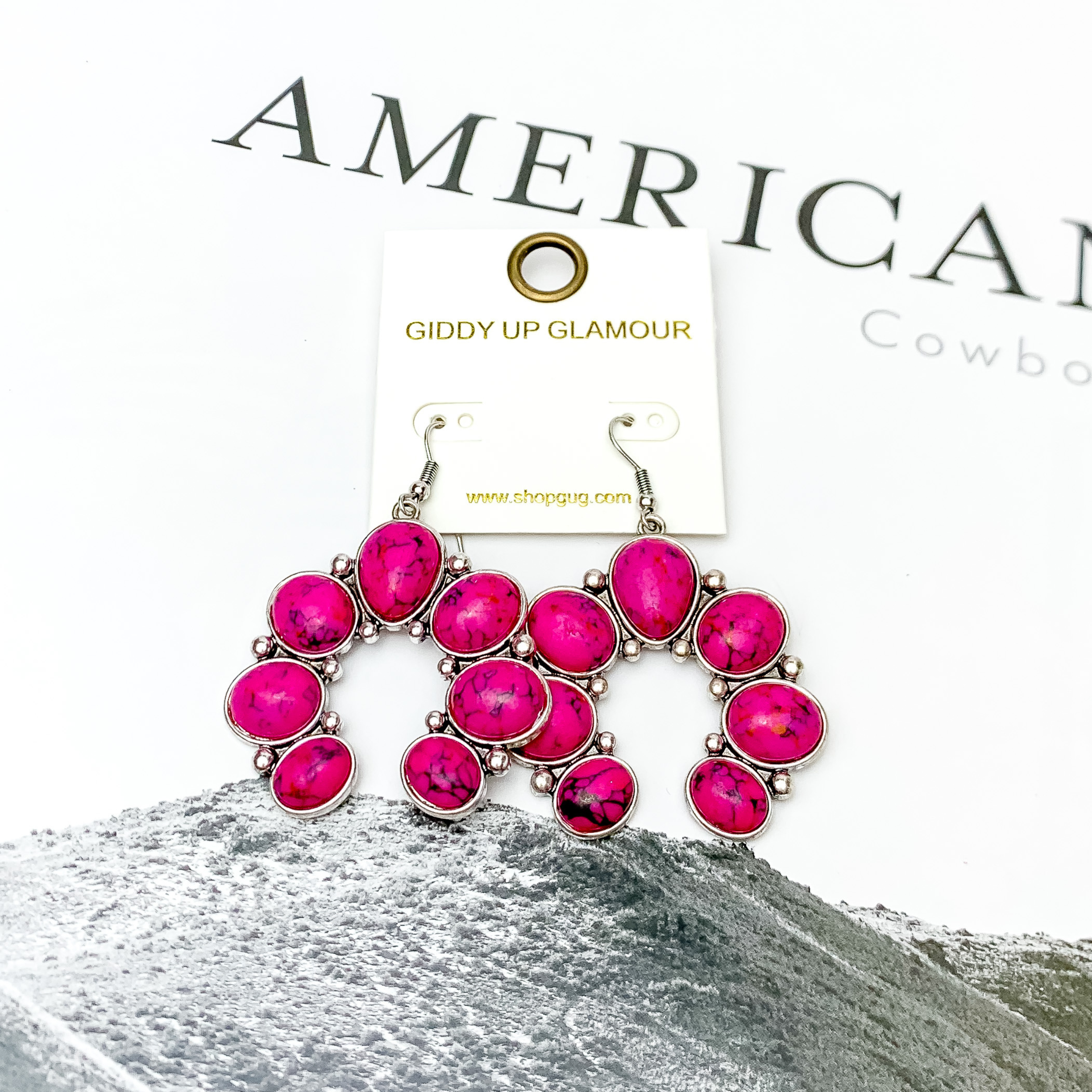 Squash Blossom Stone Earrings In Hot Pink. Pictured on a white background with American cowboy written in the background.