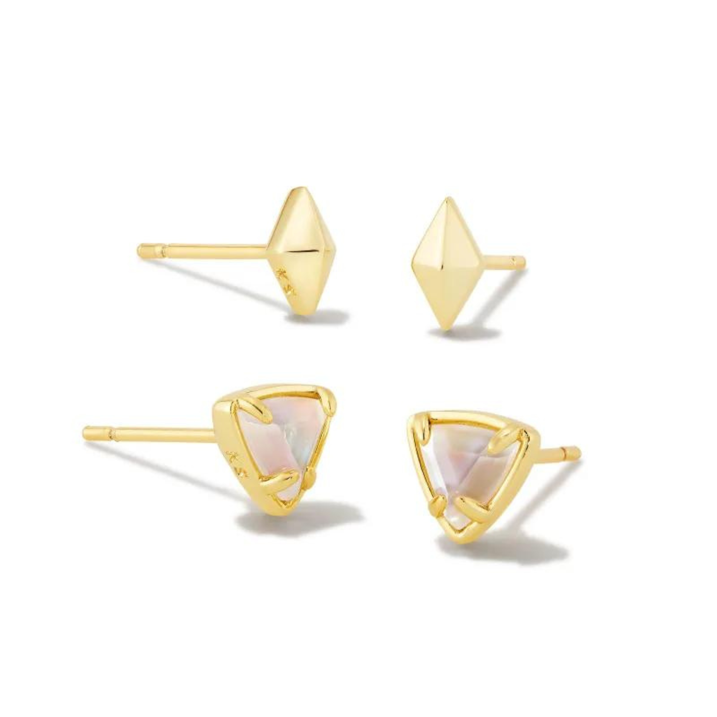 Pictured on a white background are a set of two stud earrings with gold ear posts. The top pair has a gold, diamond shaped stud. The bottom pair are gold triangle studs with ivory crystal centers. 