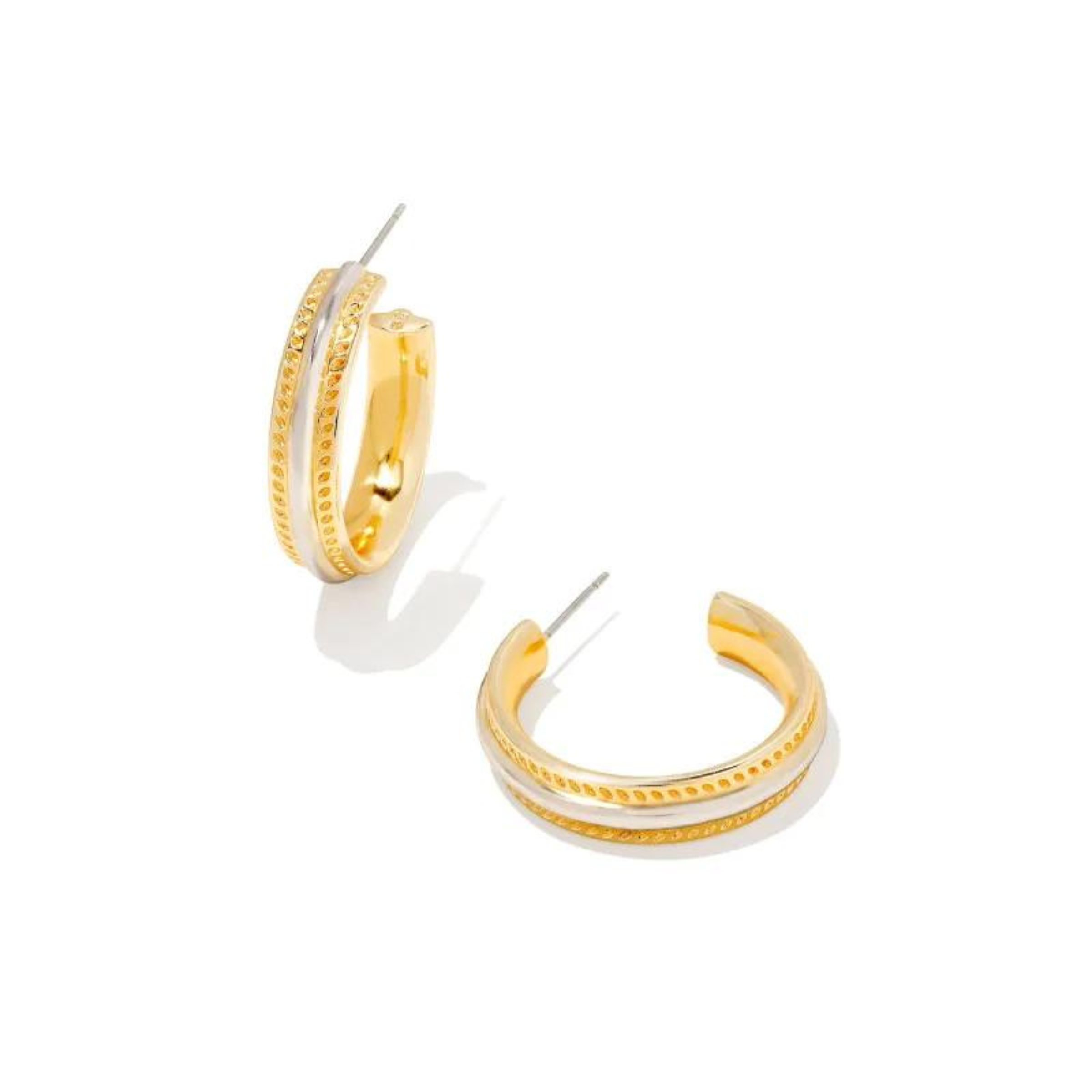 Pictured on a white background are a set gold hoop earrings with a silver center stripe. 