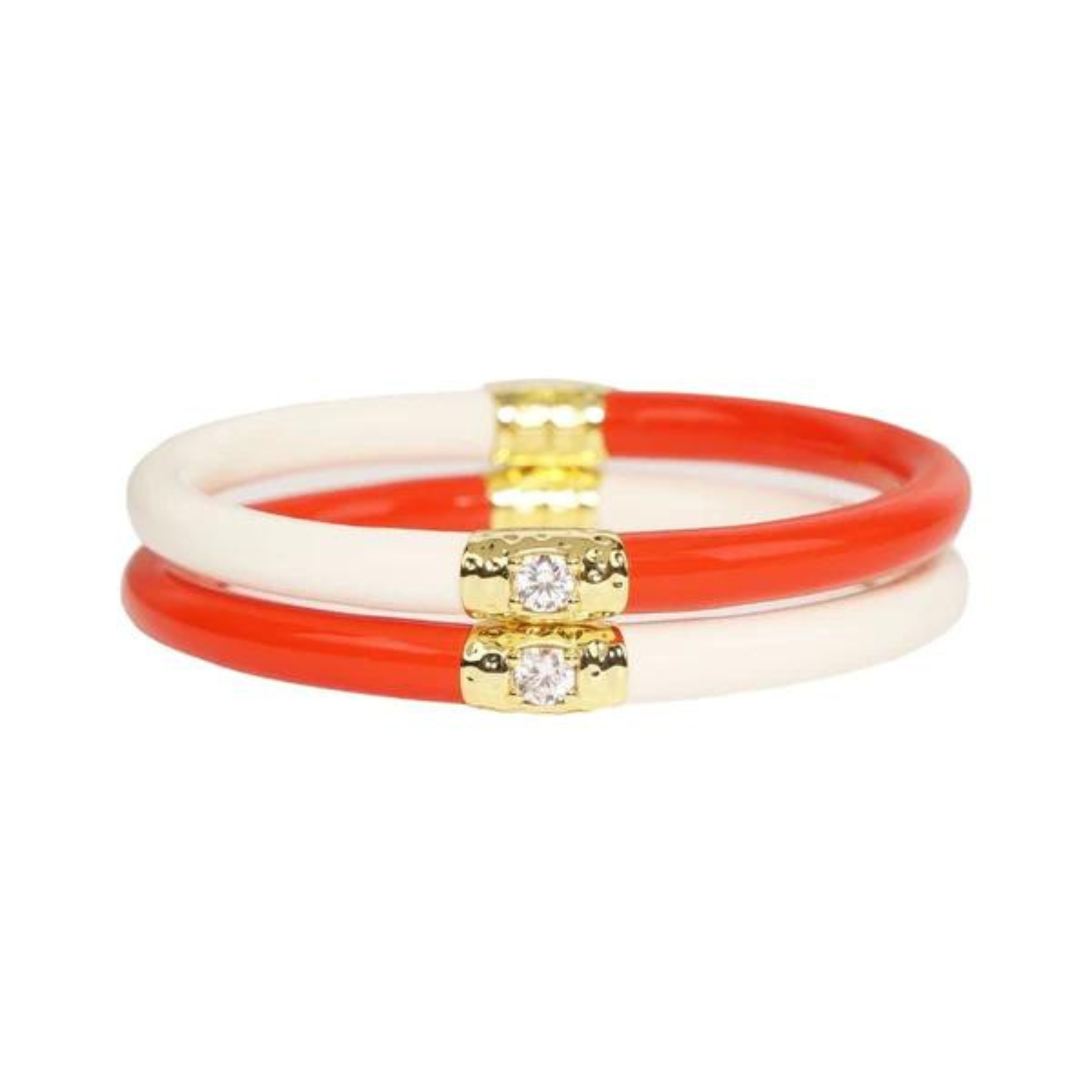 Two half white and half coral plastic, tube bracelet with two gold segments on the bracelet. These bracelets are pictured on top of each other on a white background. 