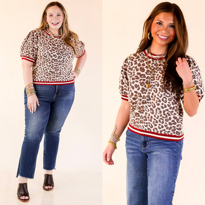 Two women wearing leopard print tops and blue jeans on a plain background