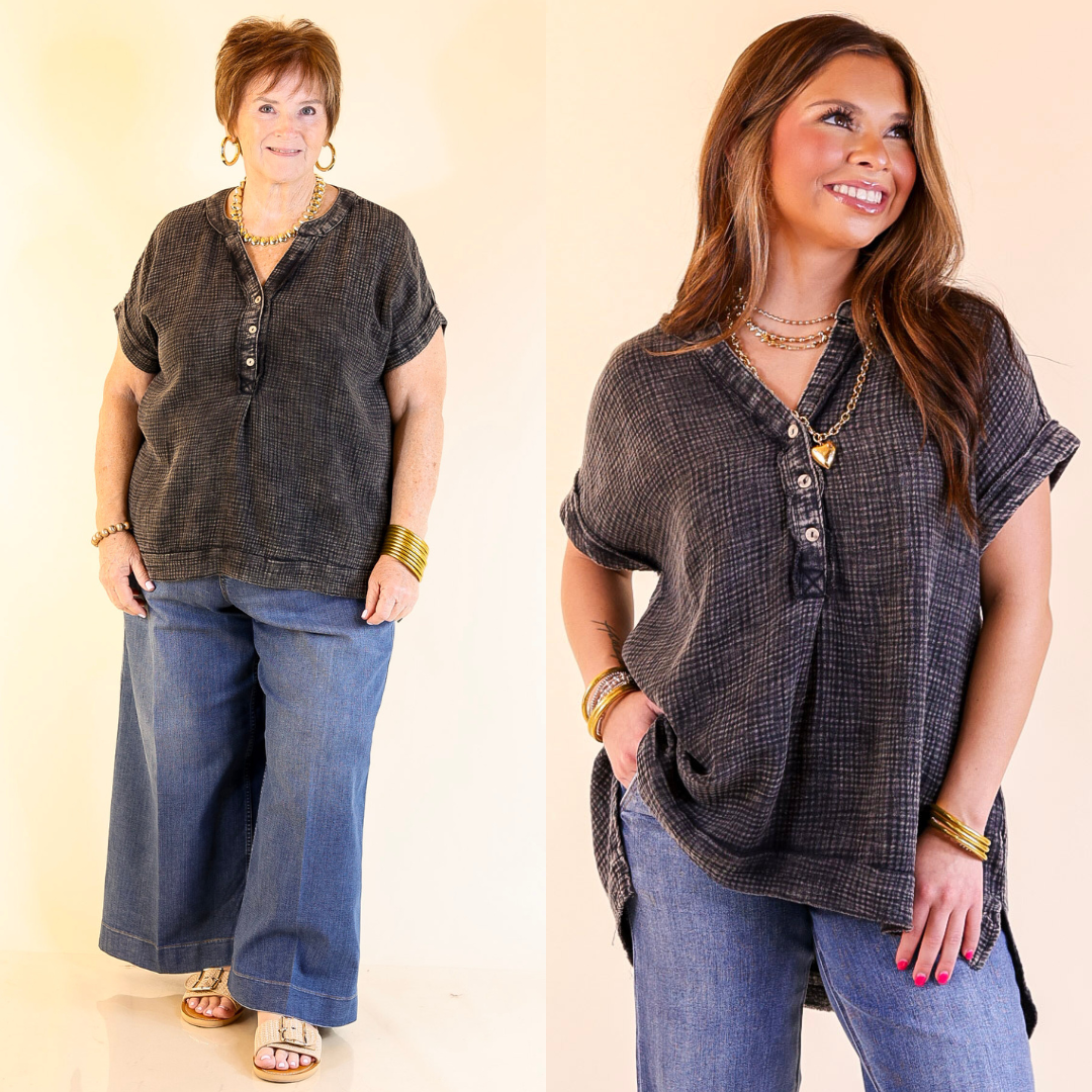 Two women wearing a black drop sleeve shirt and blue jeans against a plain background