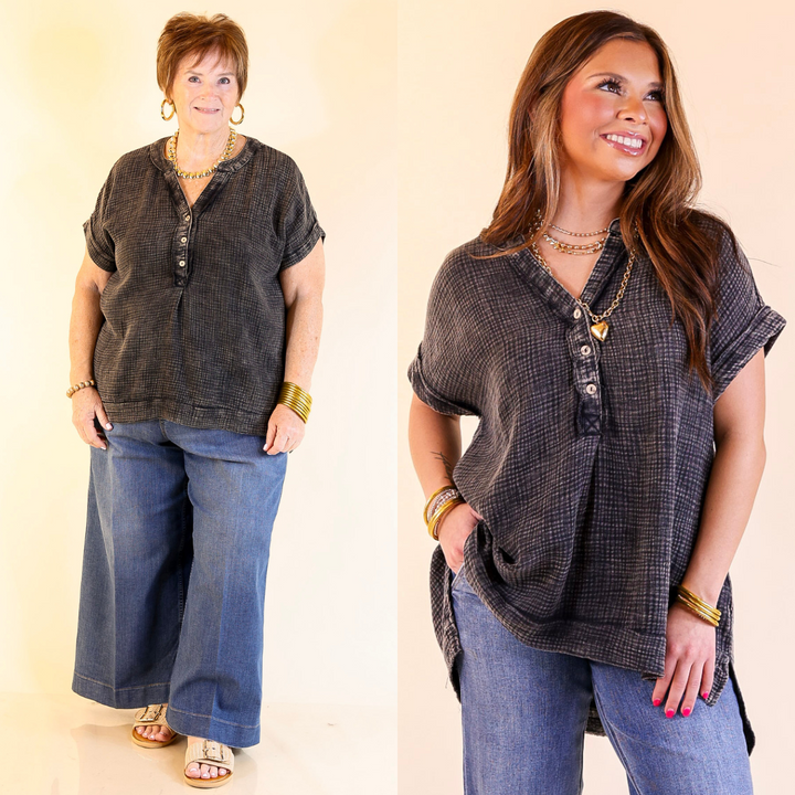 Two women wearing a black drop sleeve shirt and blue jeans against a plain background