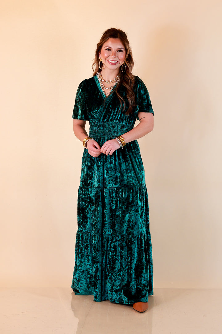 Belle of the Ball green crushed velvet maxi dress with a surplice V-neckline, flutter sleeves, smocked waist and tiered skirt, styled with layered pearls and gold hoops