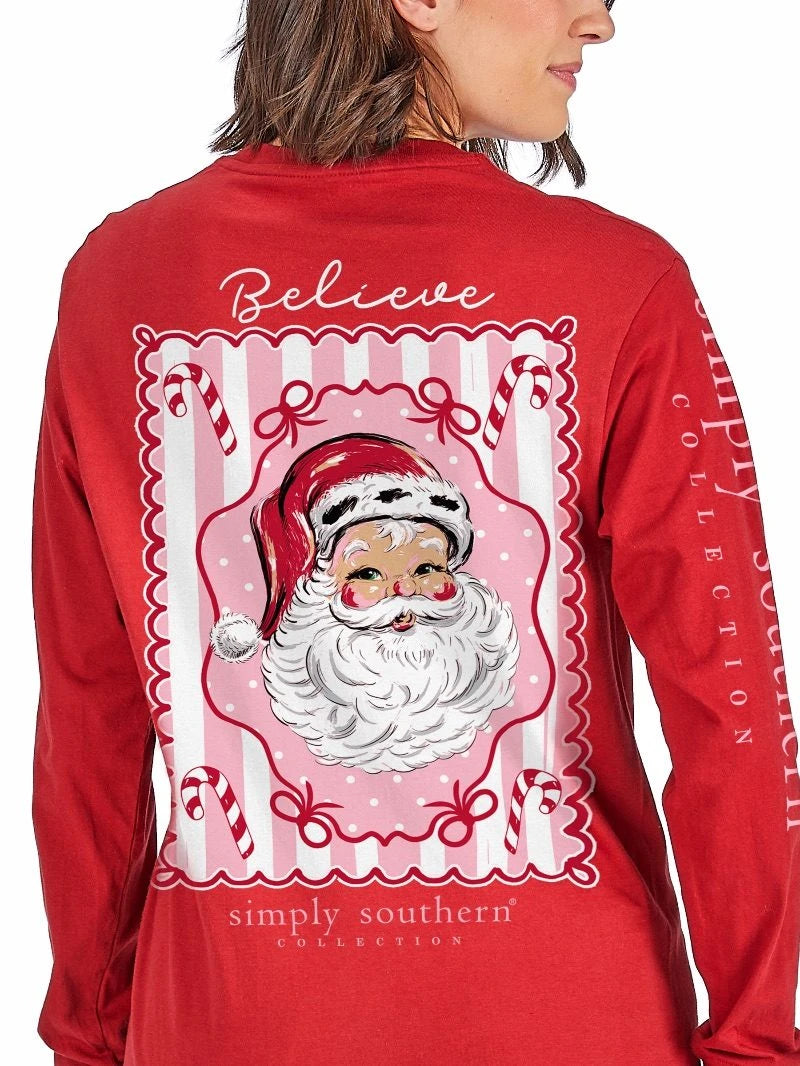 True Believer red long sleeve graphic tee back with a vintage Santa framed in pink stripes, candy canes and bows under Believe script