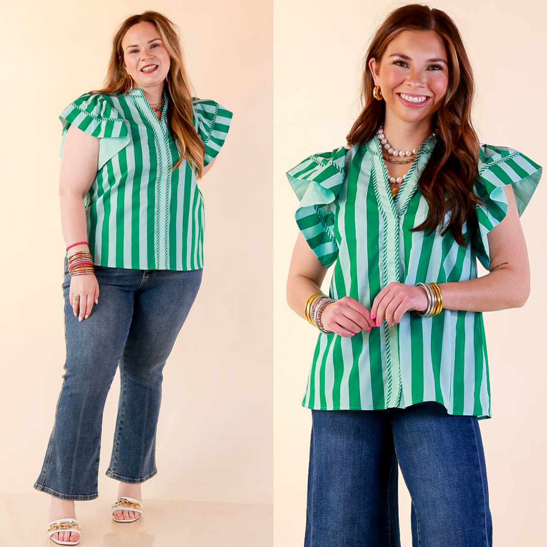 Models are wearing Striped Short Sleeve Split Neck Top in Green and Blue with Jeans against a beige backdrop. 