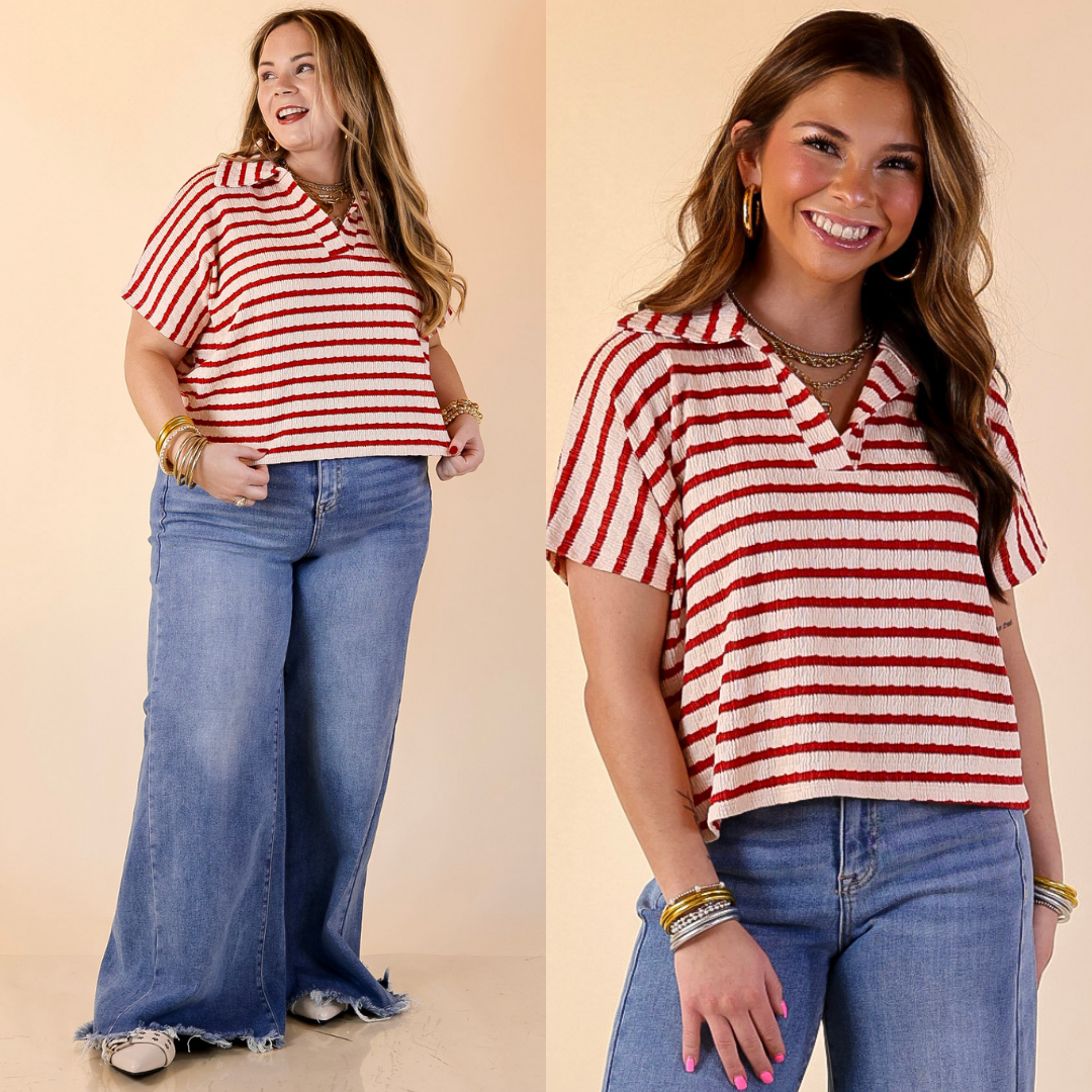 Models are wearing a red and ivory cropped top and blue jeans on a beige background.