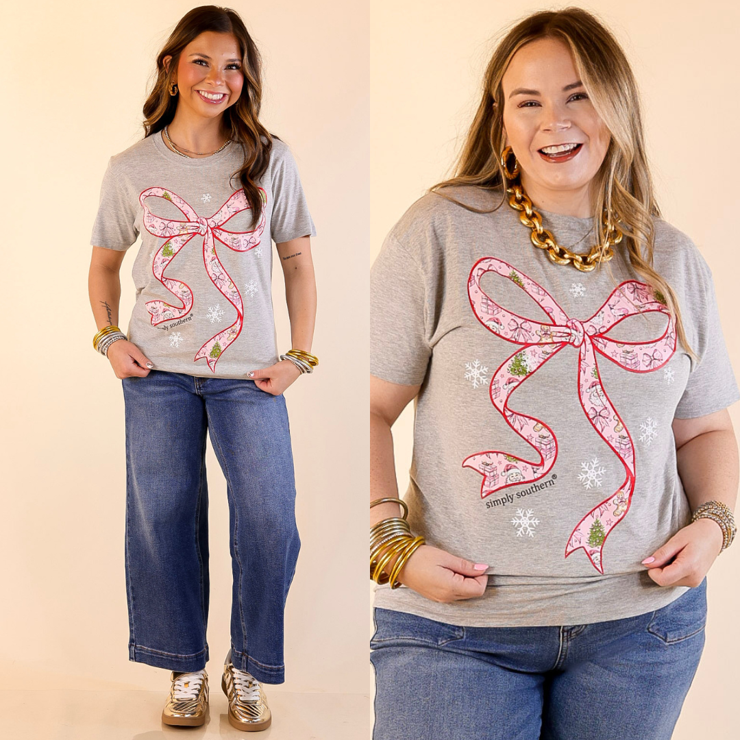 Models are wearing heather gray t-shirts with a pink bow design on a beige background