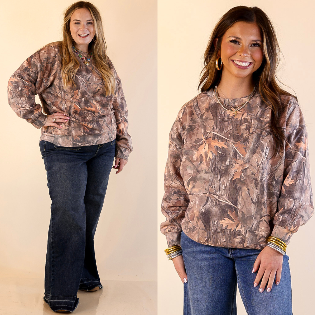 Models are wearing camouflage sweatshirts and jeans on a plain background