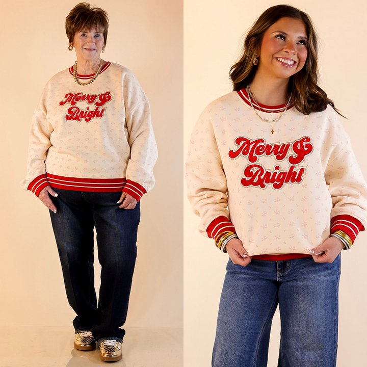 Two people wearing floral ivory varsity sweatshirts with "merry & bright" red text on a beige background