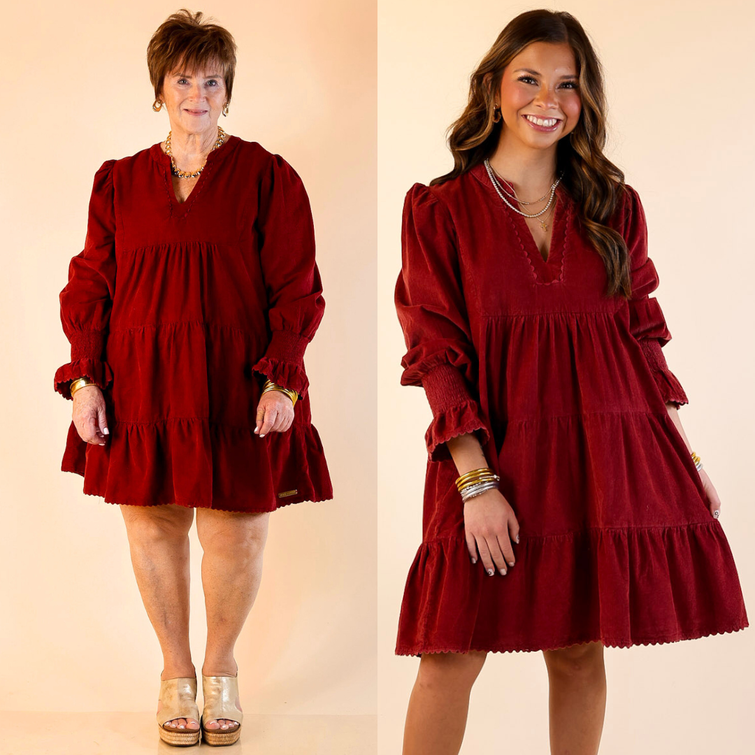 Models are wearing tiered corduroy burgundy dresses against a beige background