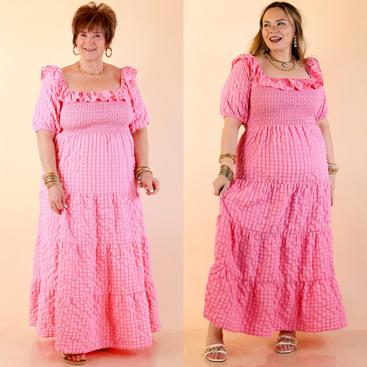 Models are wearing Textured Smocked Bodice Tired Maxi Dress with Puff Sleeve in Pink against a beige backdrop.