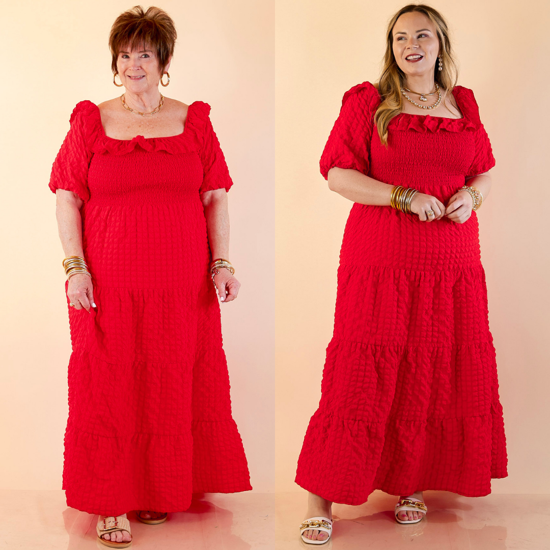 Models are wearing Textured Smocked Bodice Tired Maxi Dress with Puff Sleeve in Red against a beige backdrop.