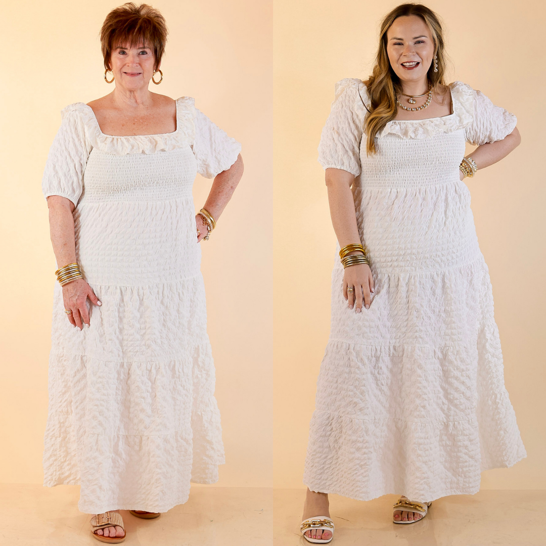 Models are wearing Textured Smocked Bodice Tired Maxi Dress with Puff Sleeve in White against a beige backdrop.