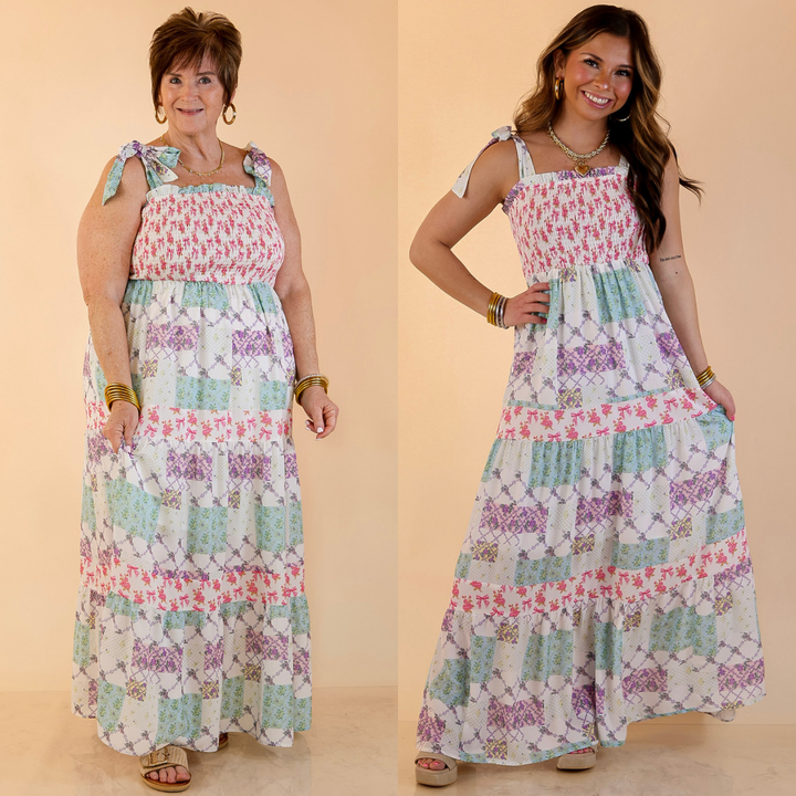 Models are wearing a multi floral tiered dress against a beige background