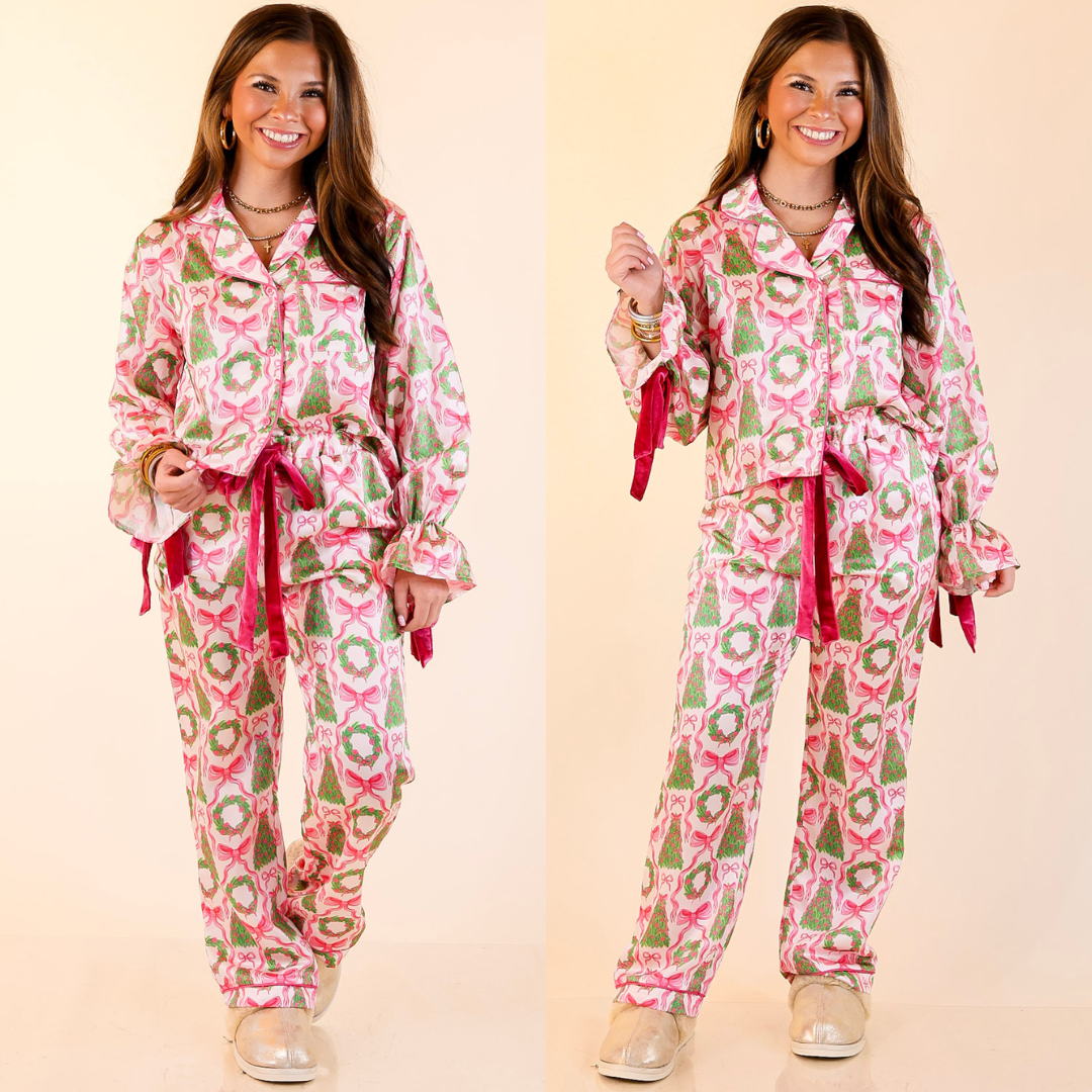 Woman wearing a bow and christmas tree detailed patterned pajama set in ivory on a beige background