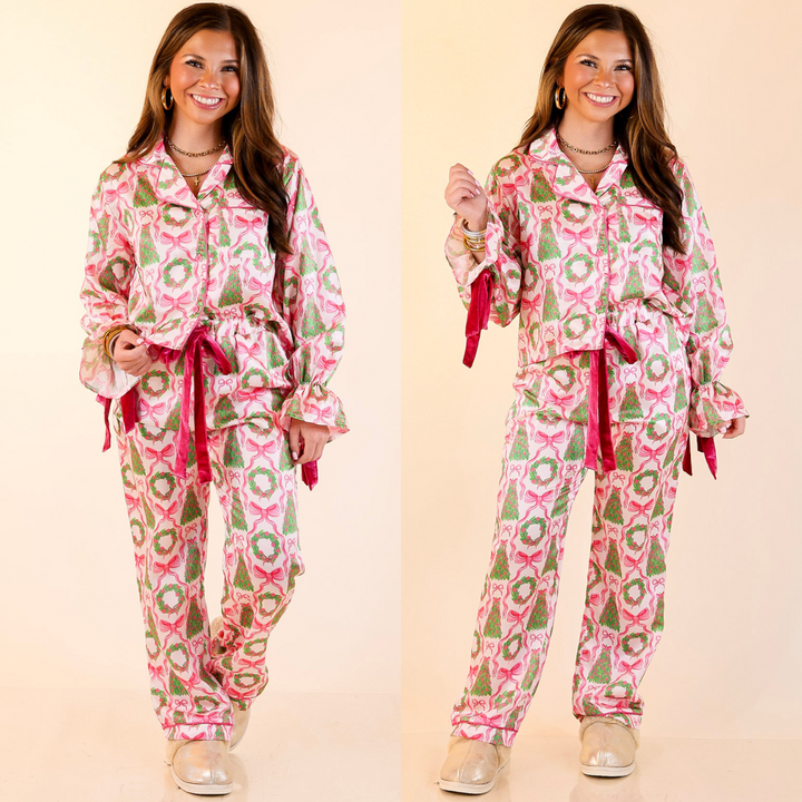 Woman wearing a bow and christmas tree detailed patterned pajama set in ivory on a beige background
