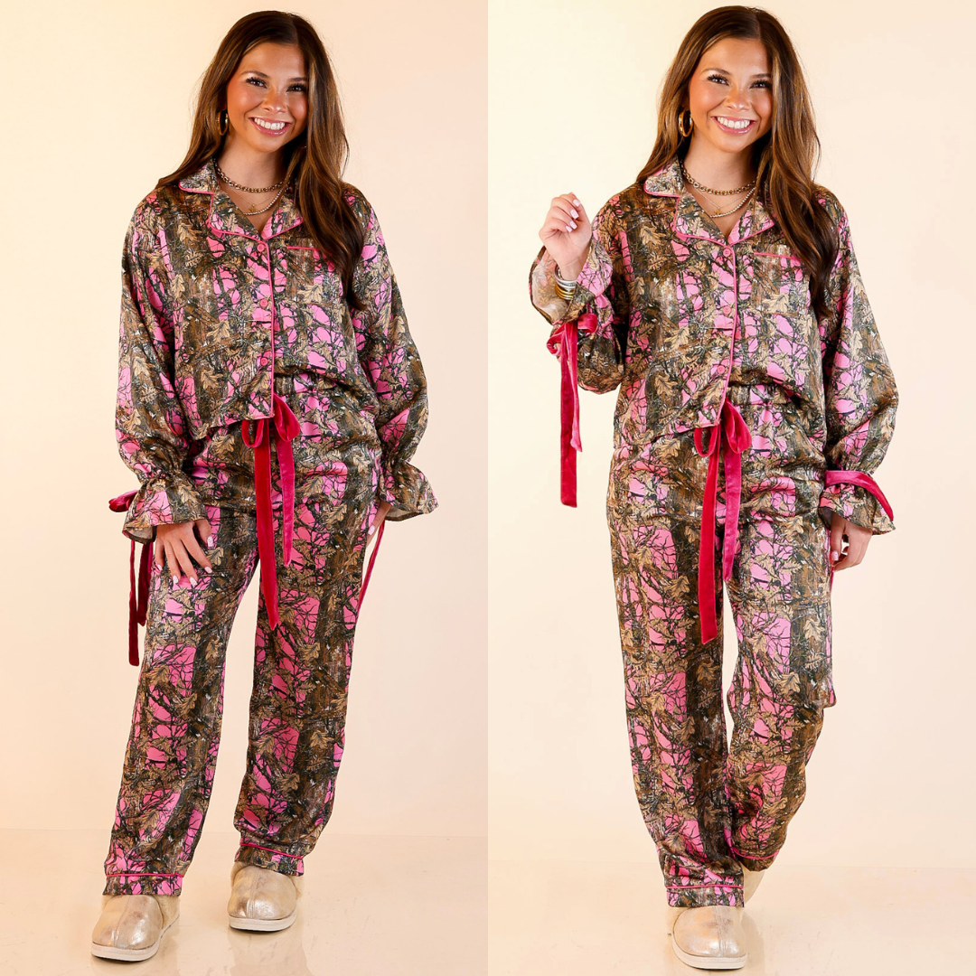 Woman wearing a pink camouflage pajama set with bow detailing on a beige background