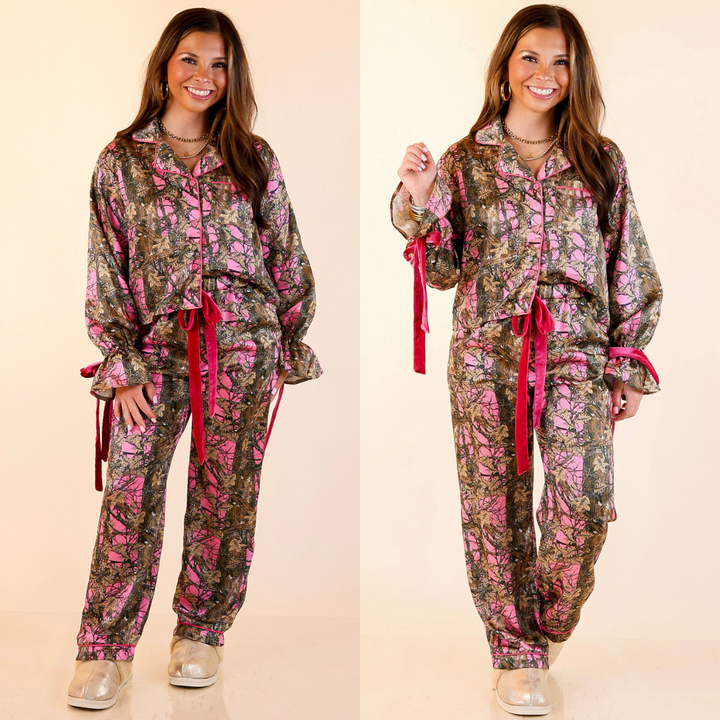 Woman wearing a pink camouflage pajama set with bow detailing on a beige background