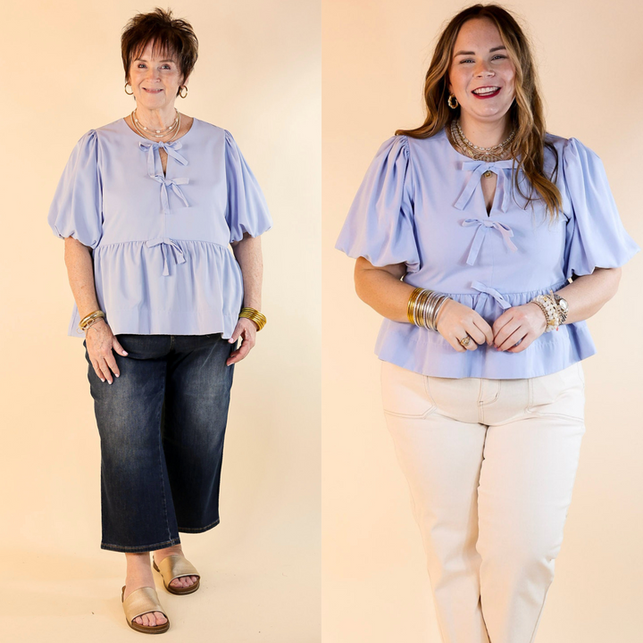 This top features delicate bow tie detailing across the front. The short puff sleeves bring a trendy and feminine flair.