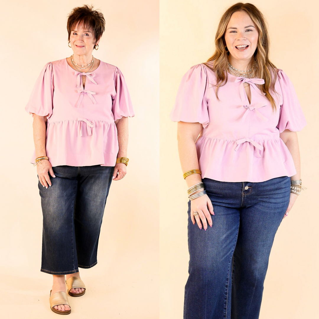 This top features delicate bow tie detailing across the front. The short puff sleeves bring a trendy and feminine flair. Sizes from small to 2XL.