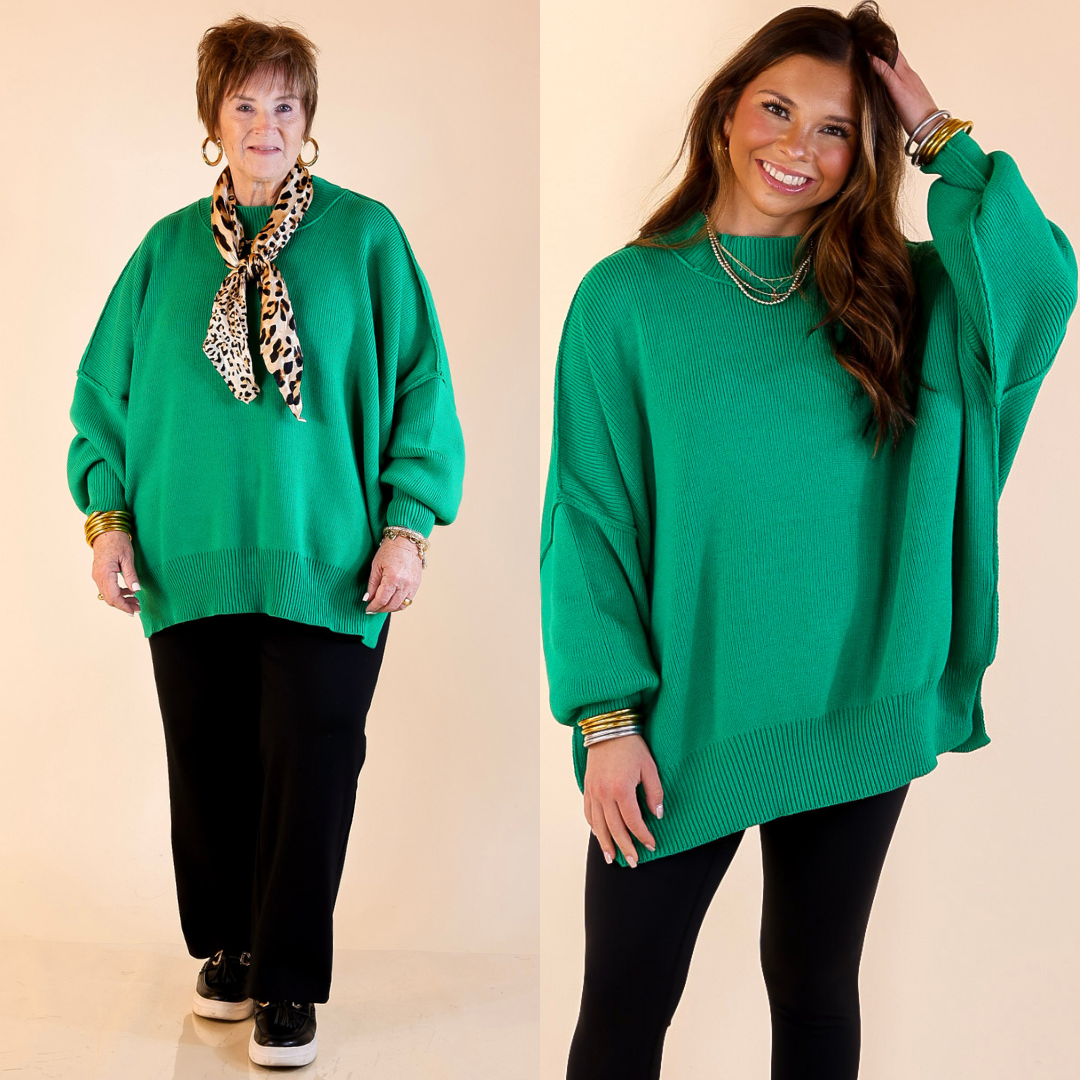 Models are wearing kelly green oversized sweater with side slit. One model is showcasing a smaller size while the other is wearing a larger size.