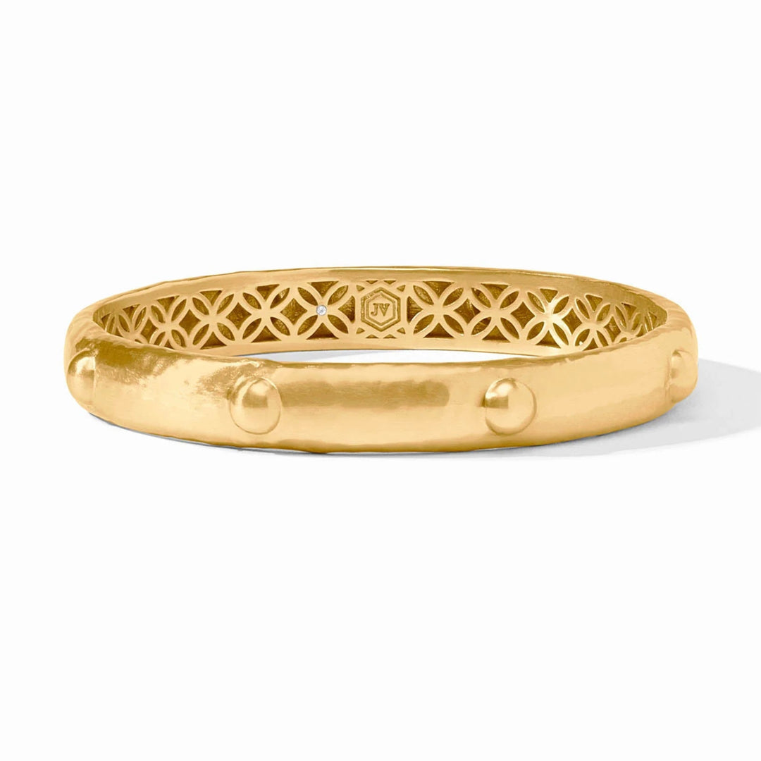 Gold bracelet with intricate design on a white background