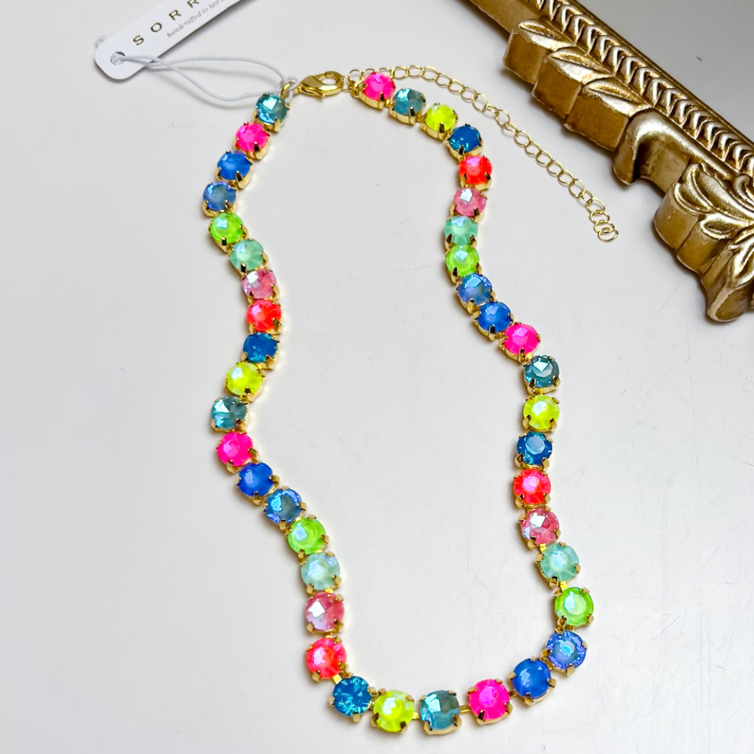 Sorrelli Matilda Tennis Necklace in Bright Gold Tone and Candy Carnival featuring round faceted crystals in vibrant pink, blue, turquoise, green, coral, and pastel shades.