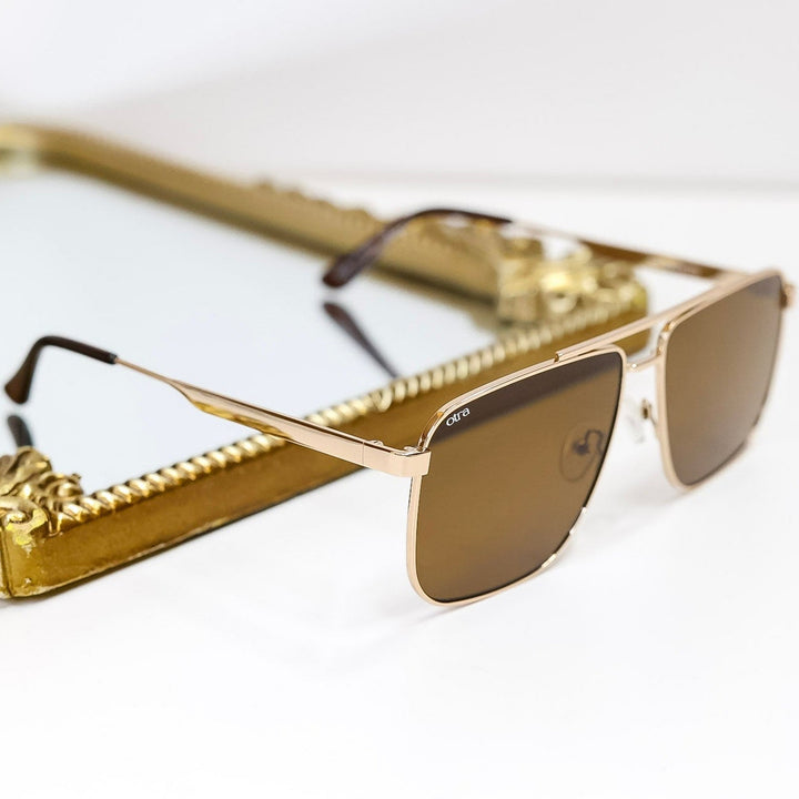 Gold-framed sunglasses on a white background